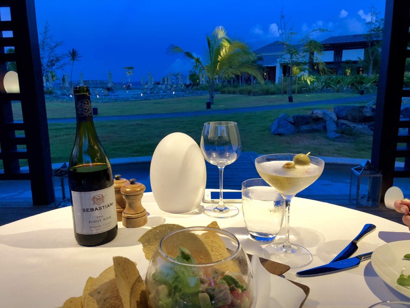 wine and appetizers set at table at dusk