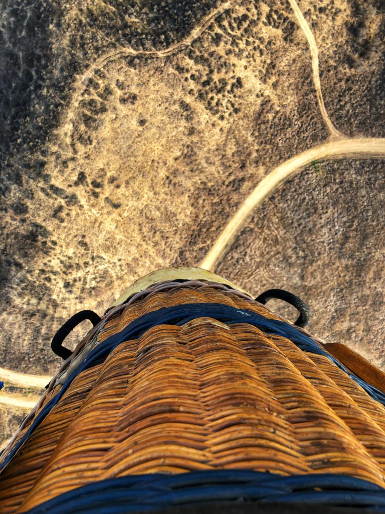 looking over the edge of the hot air balloon basket