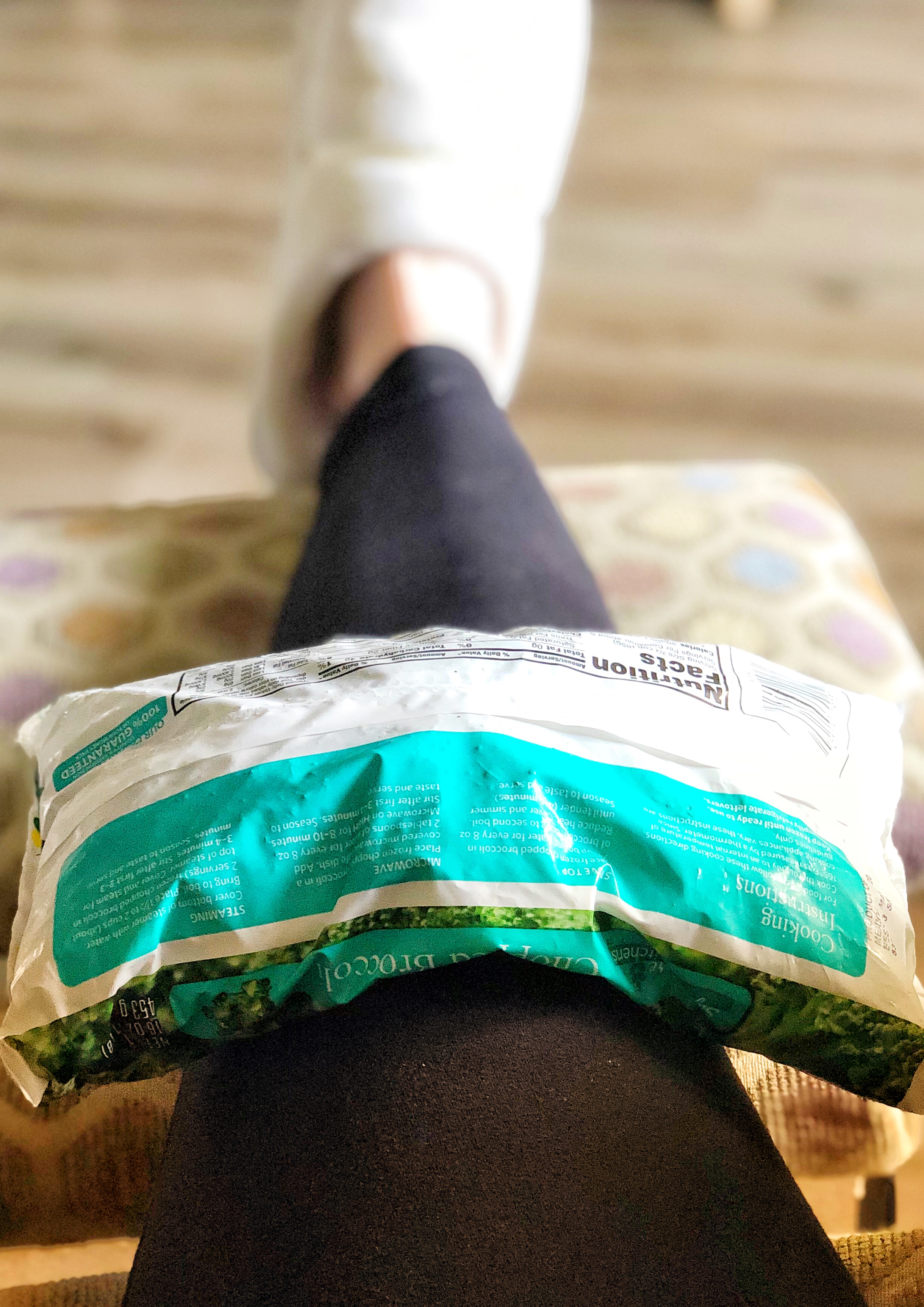 Using frozen broccoli to ice a knee injury